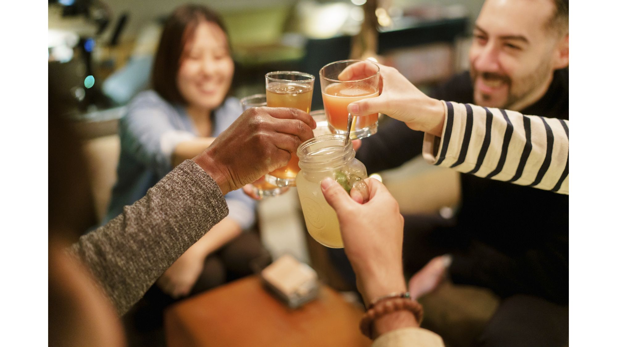 group of people toasting mixed drinks