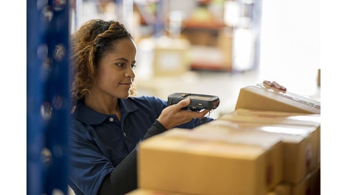 Female employee scanning boxes