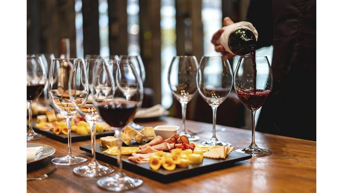 Close-up on a sommelier serving glasses of winetasting event