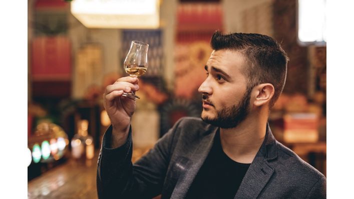 Man evaluating a spirit before tasting it. 