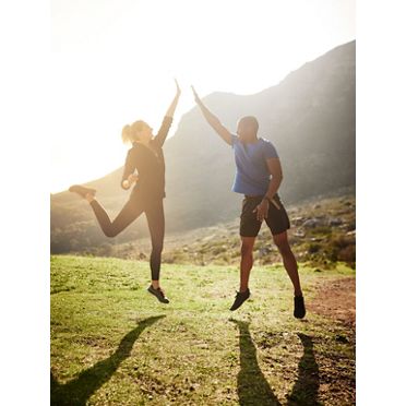 Shot of a sporty couple high-fiving after a run.