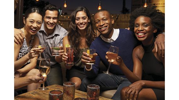 Portrait Of Friends Enjoying Night Out At Rooftop Bar