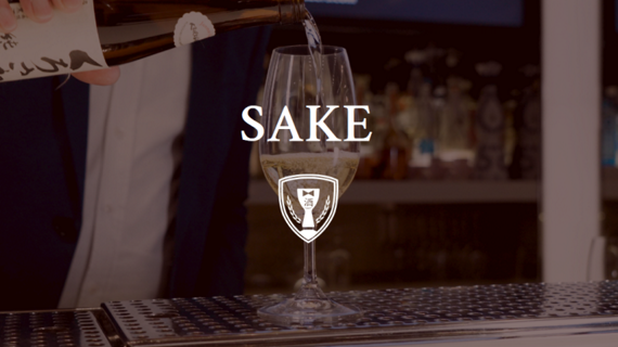 server pouring glass of sake