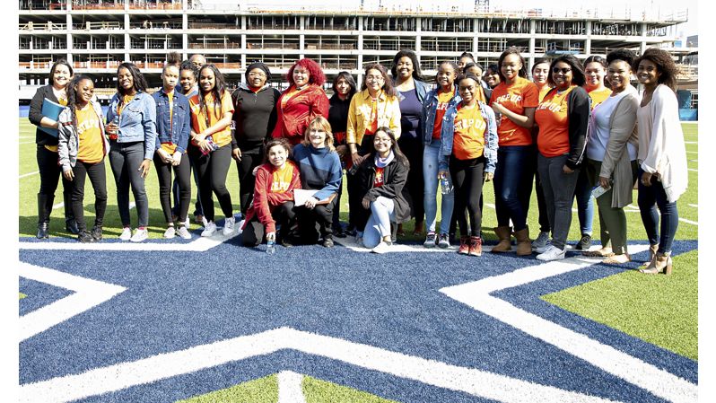 Diverse group of students on Dallas Cowboys football field