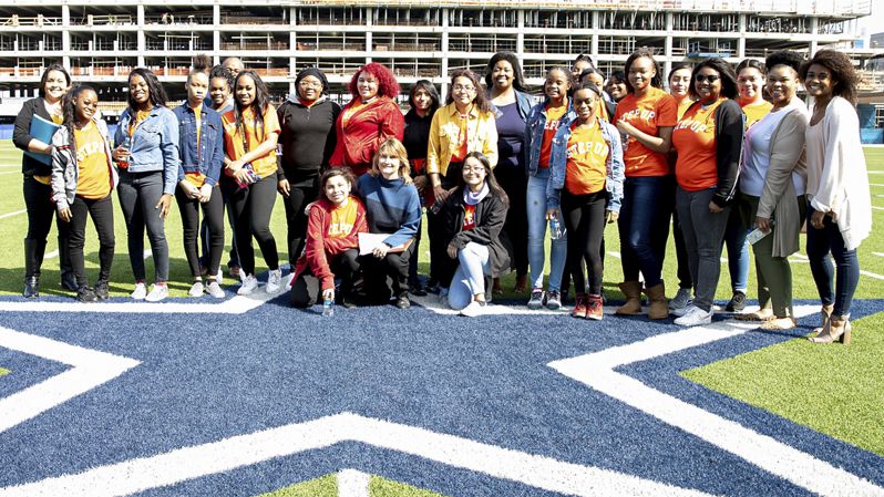 Diverse group of students on Dallas Cowboys football field