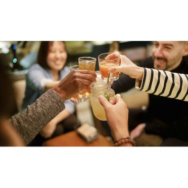  Orange alcoholic cocktail drink Cosmopolitan decorated with orange peel on bar counter