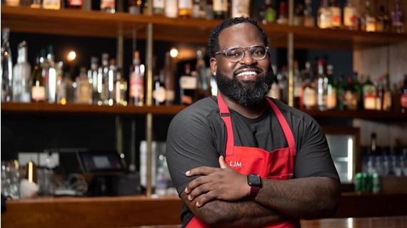 Chef standing in front of bar