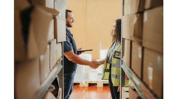 Warehouse handshake, shipping deal and partnership in logistics factory, manufacturing and export industry. Job buyer and supplier shaking hands for b2b agreement, meeting contract and teamwork sale