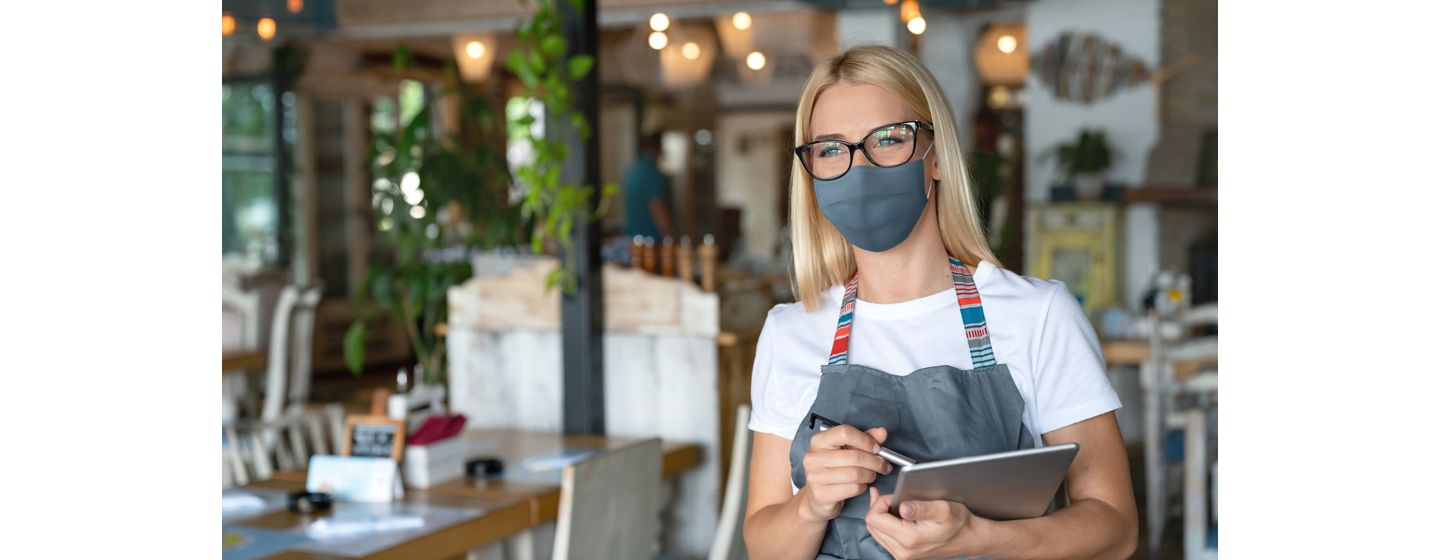 Woman in restaurant working on tablet