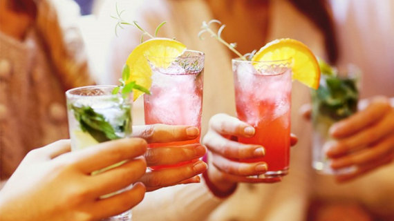four-people-with-drinks-in-hand