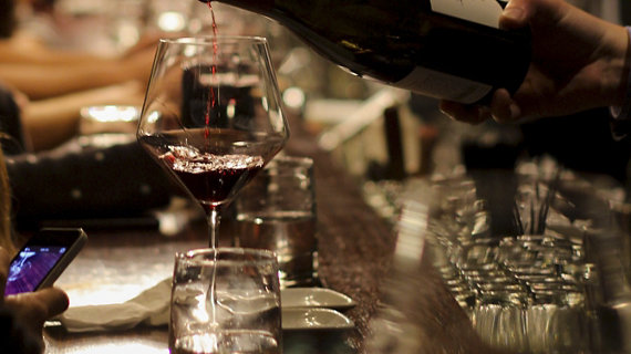 Close up of red wine being poured into a glass
