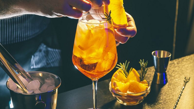 bartender creating spritz cocktail