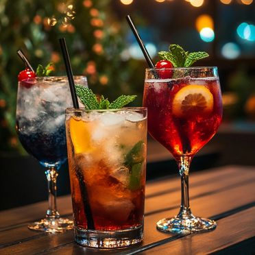 Vibrant cocktail trio showcasing mixology artistry, illuminated by soft bokeh lights, creating an inviting evening ambiance of sophisticated drink craftsmanship and social elegance.