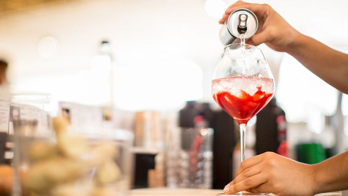a canned drink being poured into a glass
