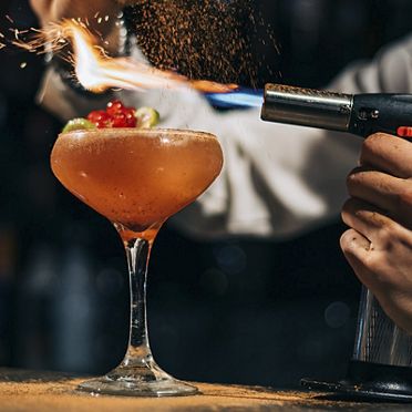 mixed drink being light on fire
