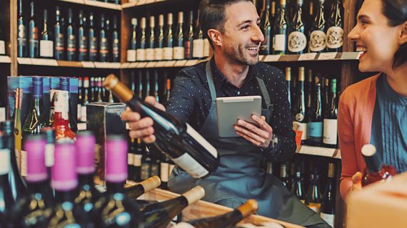 Man and woman looking at wine