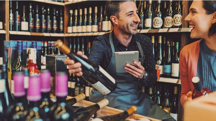 Man and woman looking at wine